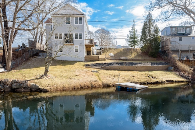 rear view of house with a water view and stairs