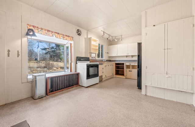 kitchen with visible vents, electric range oven, rail lighting, white cabinets, and a sink