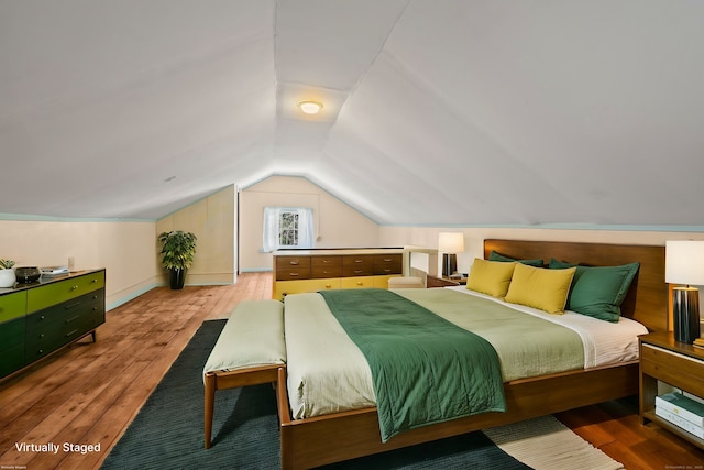 bedroom with hardwood / wood-style floors and vaulted ceiling