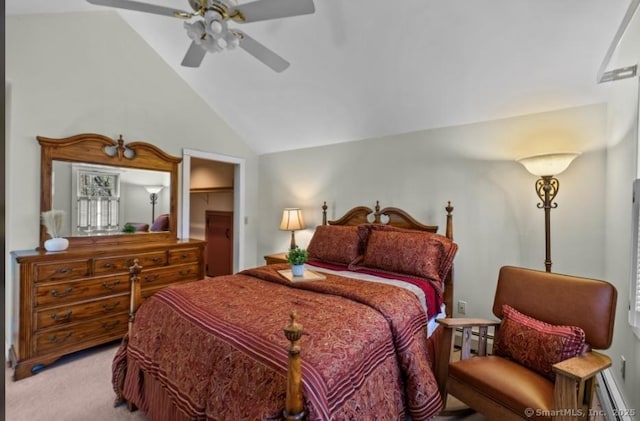 bedroom featuring a spacious closet, ceiling fan, lofted ceiling, light carpet, and baseboard heating