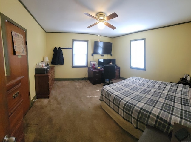 bedroom with baseboards, a ceiling fan, ornamental molding, and carpet flooring