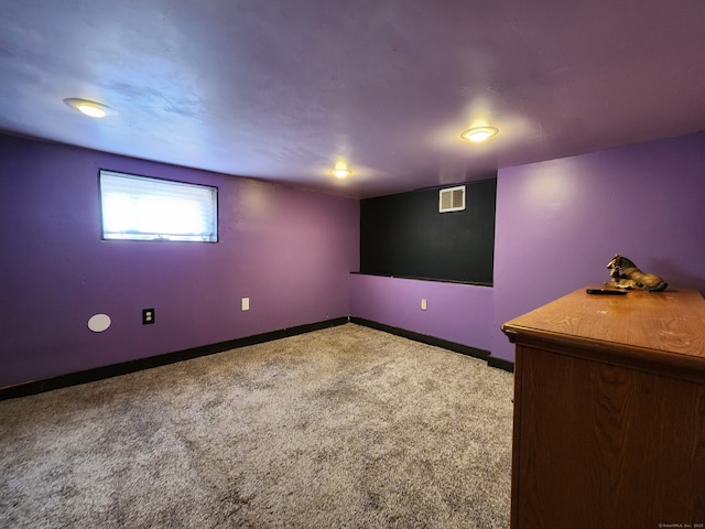 below grade area with carpet flooring, baseboards, and visible vents