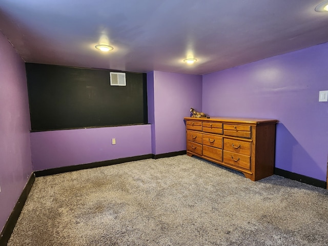 unfurnished bedroom featuring carpet flooring, visible vents, and baseboards