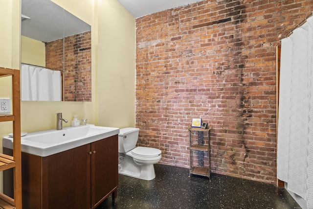 full bath with vanity, tile patterned floors, toilet, and brick wall