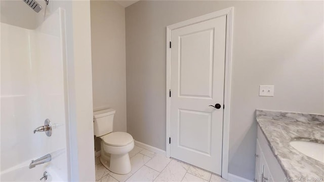 bathroom with vanity, toilet, baseboards, and shower / bathtub combination