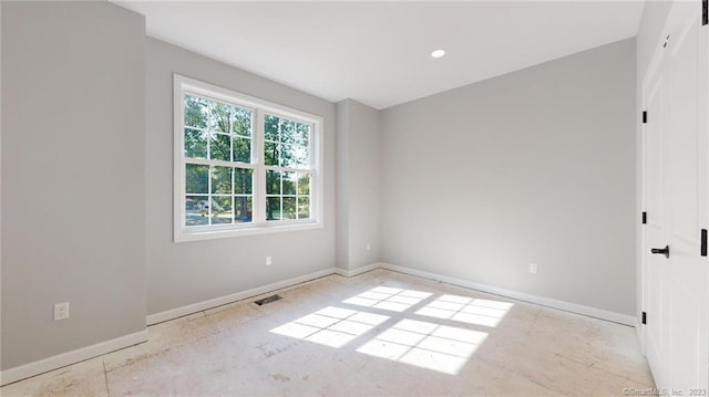 unfurnished room with visible vents and baseboards