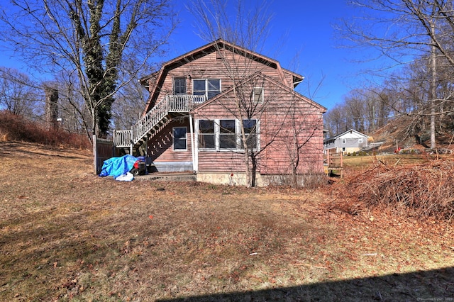 exterior space with a gambrel roof and stairs