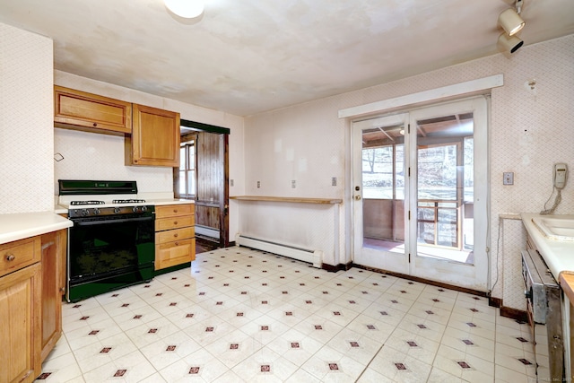 kitchen featuring wallpapered walls, range with gas cooktop, light floors, light countertops, and a baseboard radiator