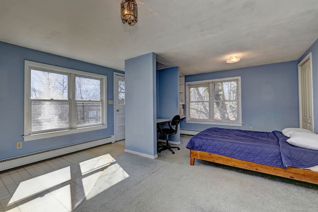 bedroom with a baseboard radiator, baseboards, and carpet flooring