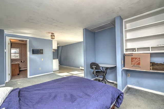 carpeted bedroom with a baseboard radiator, washer / dryer, baseboards, and connected bathroom