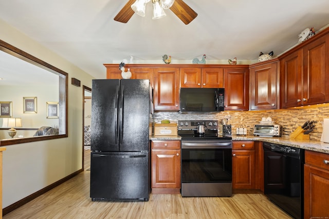 kitchen with tasteful backsplash, black appliances, and light wood finished floors