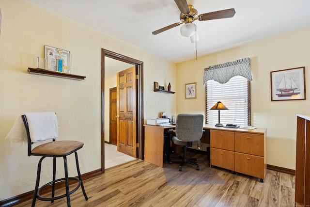 office with baseboards, light wood-style flooring, and a ceiling fan