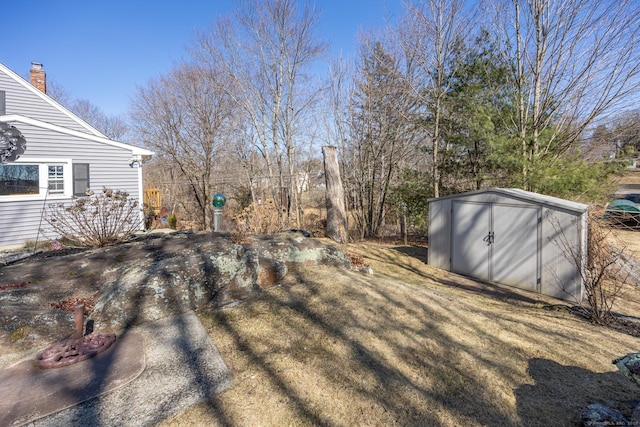 view of yard with an outbuilding and a storage shed