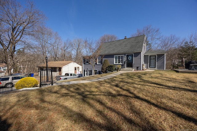 view of front of home with entry steps, roof with shingles, a front lawn, and fence