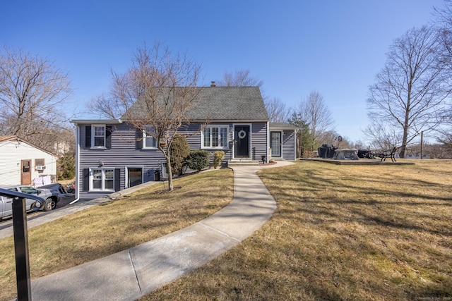 view of front of property with a front lawn and a shingled roof