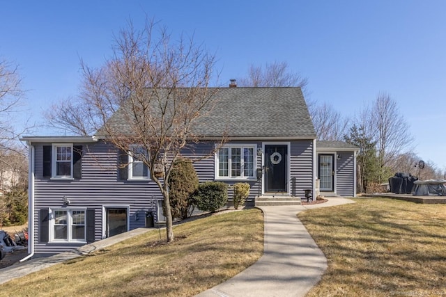 view of front of property with a chimney, roof with shingles, and a front yard