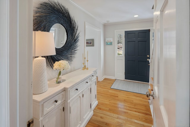 entryway with light wood-style flooring, recessed lighting, baseboards, and ornamental molding