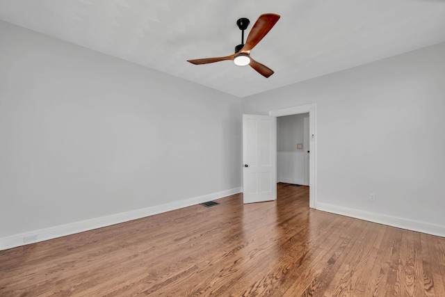 unfurnished bedroom with visible vents, baseboards, wood finished floors, and a ceiling fan