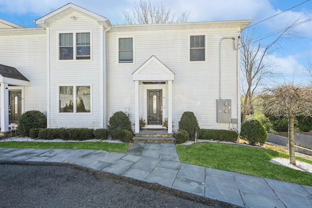 view of front of home featuring a front yard and fence