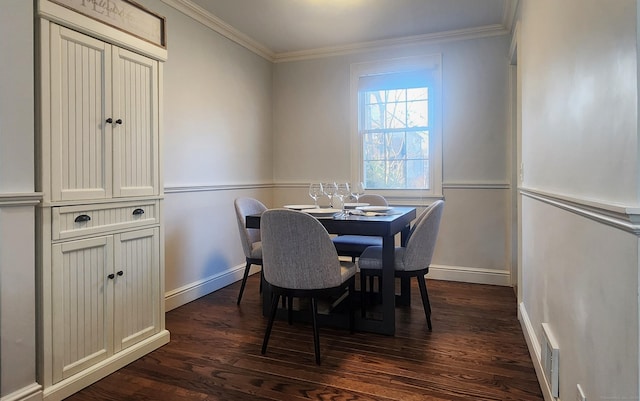 dining space with dark wood-style floors, baseboards, and ornamental molding