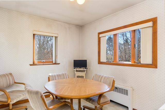 dining area featuring wallpapered walls and radiator heating unit