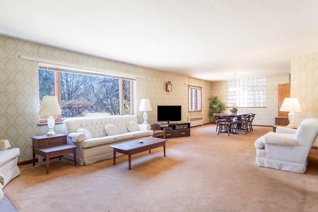 carpeted living room with wallpapered walls and baseboards