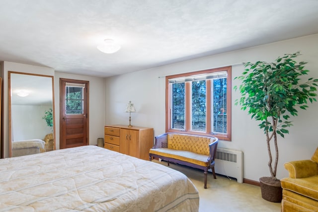 bedroom featuring radiator heating unit and carpet floors