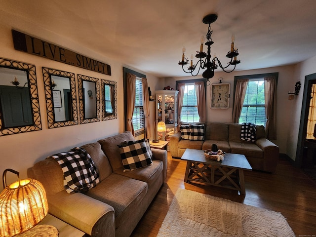 living room with a chandelier and wood finished floors