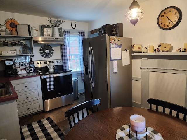 kitchen with dark tile patterned floors, a sink, appliances with stainless steel finishes, and open shelves