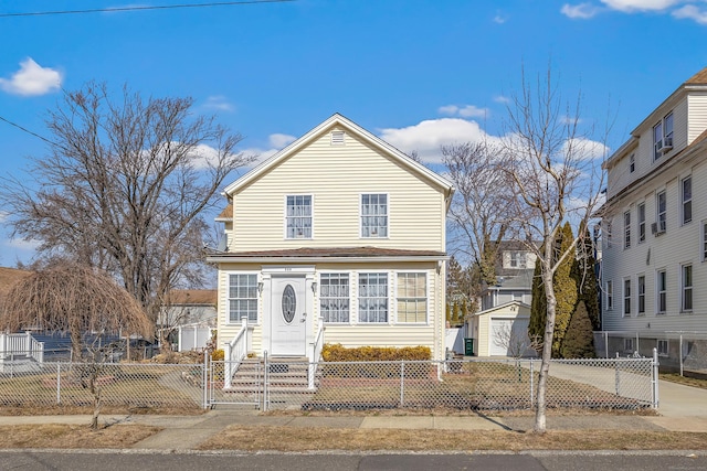 traditional home with a fenced front yard, an outdoor structure, and entry steps