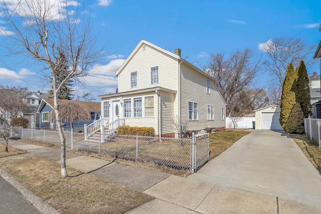 traditional home with a fenced front yard, a detached garage, a chimney, and an outbuilding