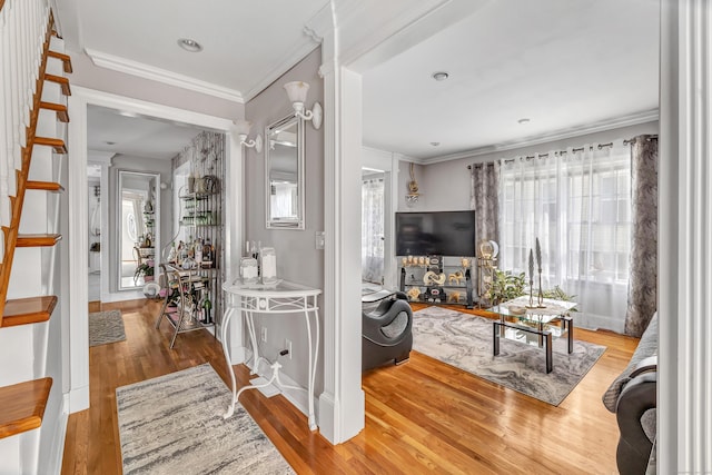 entrance foyer featuring crown molding, baseboards, and wood finished floors