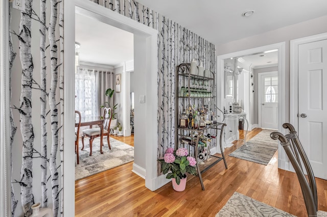 entrance foyer featuring light wood-style flooring, plenty of natural light, and baseboards