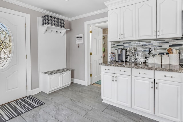 mudroom with marble finish floor, baseboards, and ornamental molding