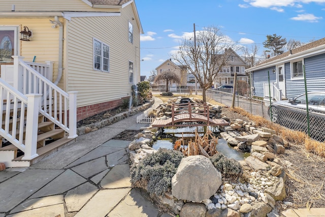 view of yard featuring a residential view and fence