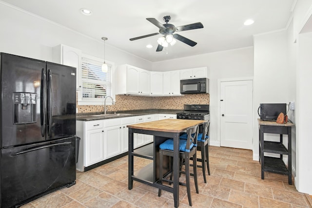 kitchen with ornamental molding, decorative backsplash, black appliances, white cabinets, and a sink