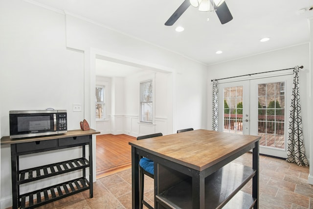 dining area with recessed lighting, french doors, a wainscoted wall, and crown molding