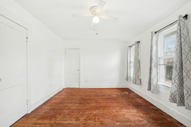 spare room featuring baseboards, ceiling fan, and wood finished floors