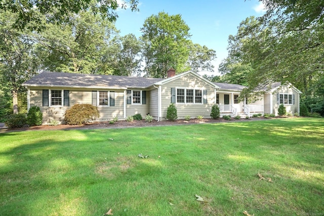 ranch-style house with a front lawn and a chimney