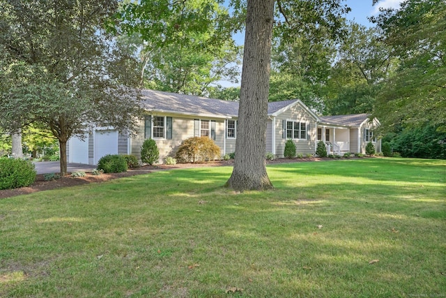 ranch-style house with driveway, a front yard, and a garage