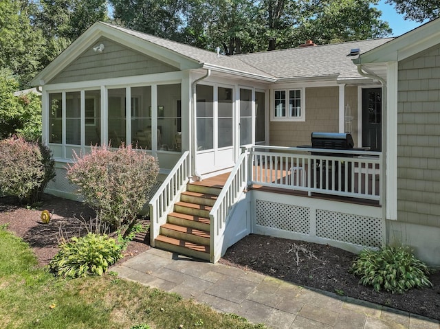 exterior space with a wooden deck and a shingled roof