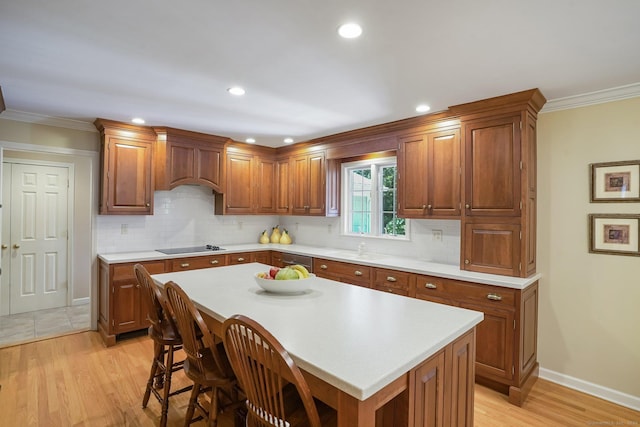 kitchen with light countertops, premium range hood, and light wood finished floors