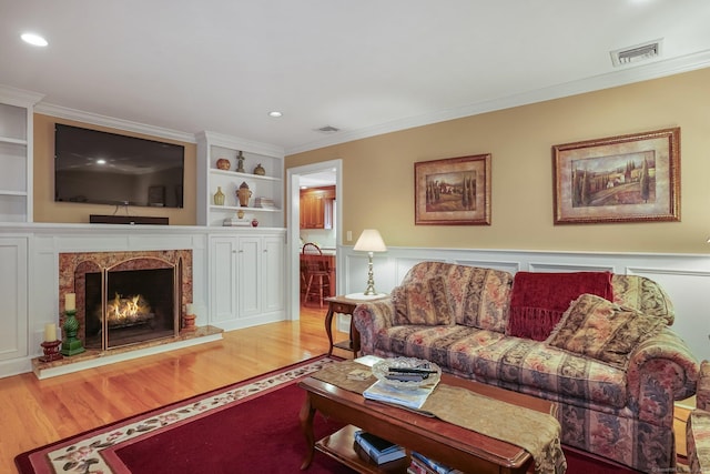 living room with visible vents and ornamental molding