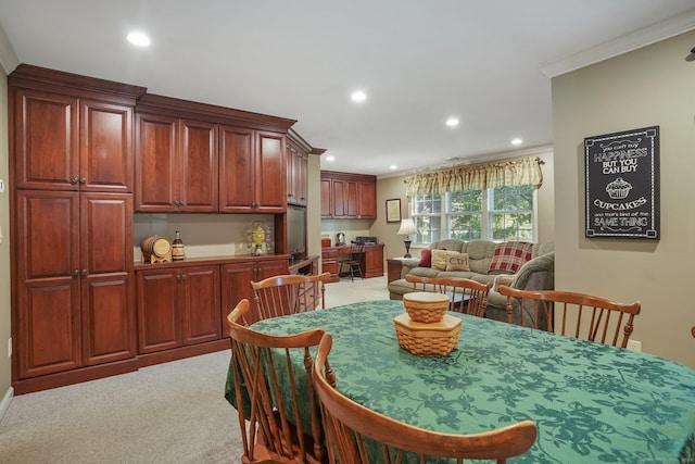 dining area with recessed lighting, light colored carpet, and crown molding