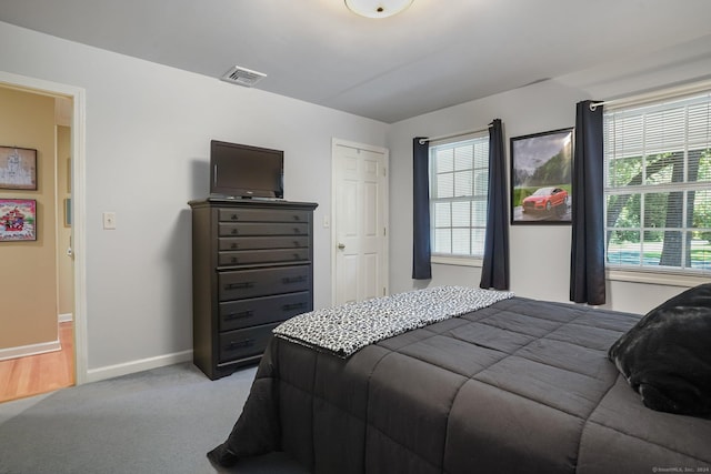 carpeted bedroom with visible vents and baseboards