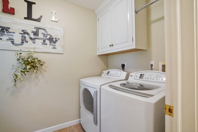 clothes washing area featuring cabinet space, baseboards, and separate washer and dryer