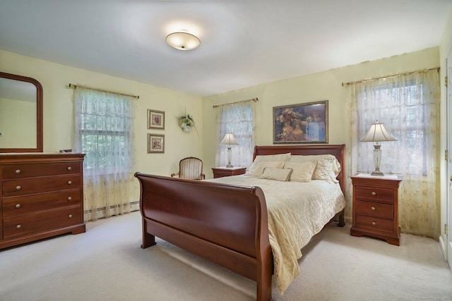 bedroom with carpet and a baseboard radiator