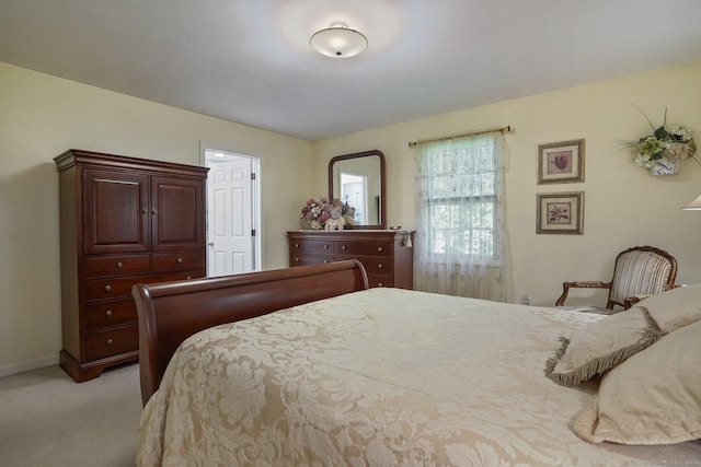 bedroom featuring light carpet and baseboards