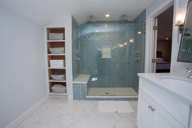 ensuite bathroom with a shower stall, baseboards, ensuite bath, marble finish floor, and vanity