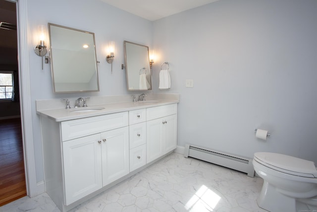 bathroom with a sink, a baseboard heating unit, marble finish floor, and double vanity